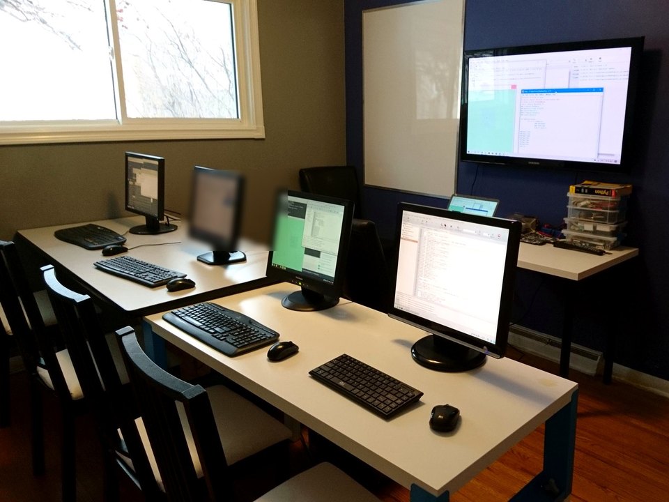 A compact room with several computer workstations.